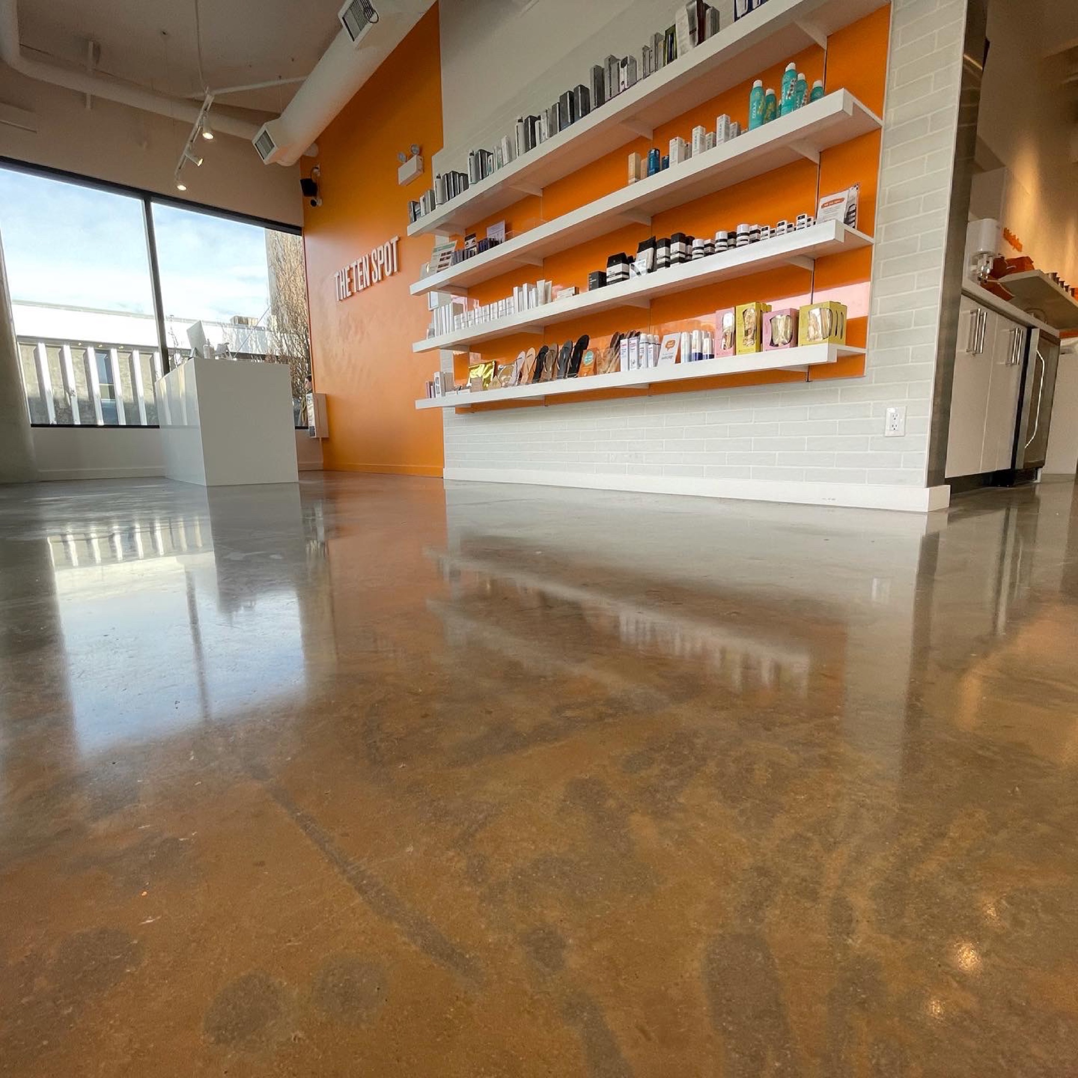 The 10 Spot polished concrete floor in a commercial salon interior.
