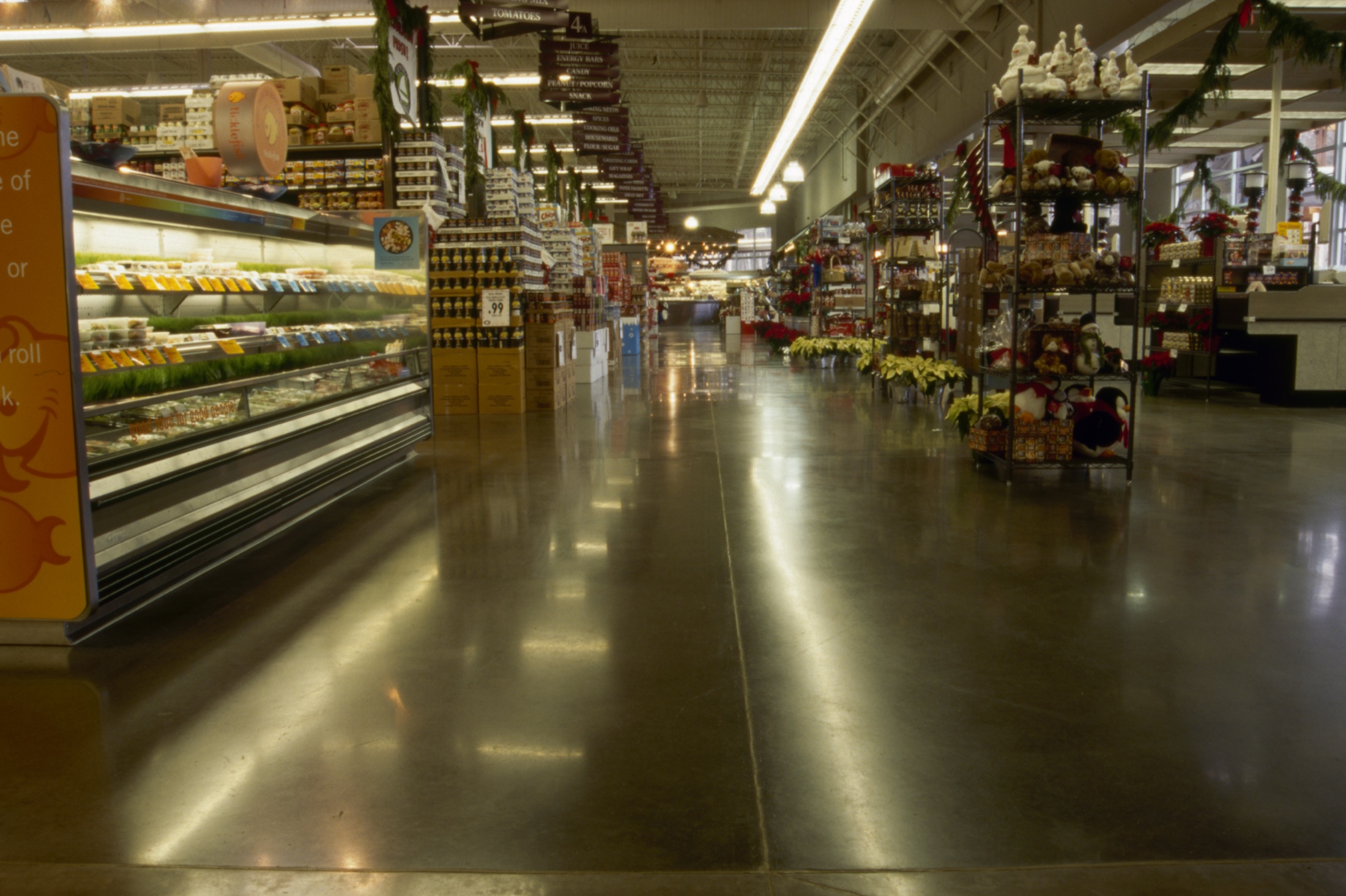 Unnamed grocery store polished concrete floor through retail aisles.