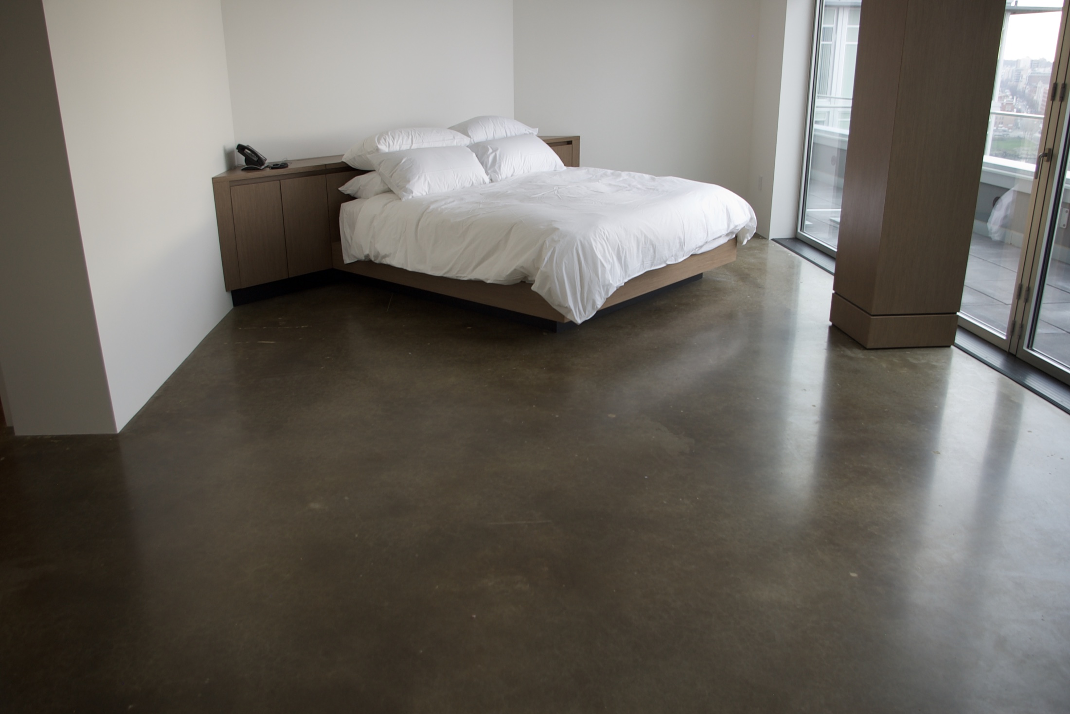 Unnamed residential bedroom with polished concrete floor.
